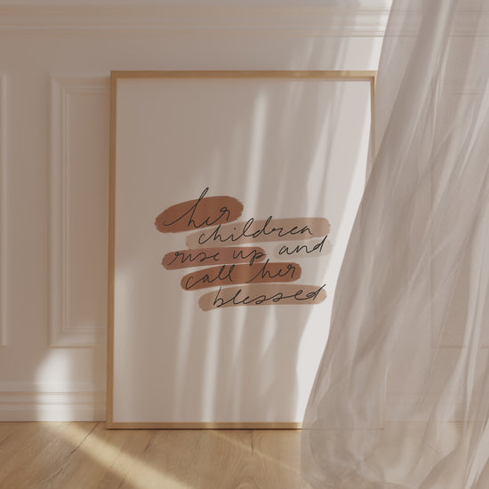 Printable scripture wall art for Mother’s Day displayed in a warm, cozy room with soft textures and sunlit wood tones.